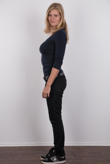 Pretty blonde Adriana strips off her jeans to show her big saggy breasts