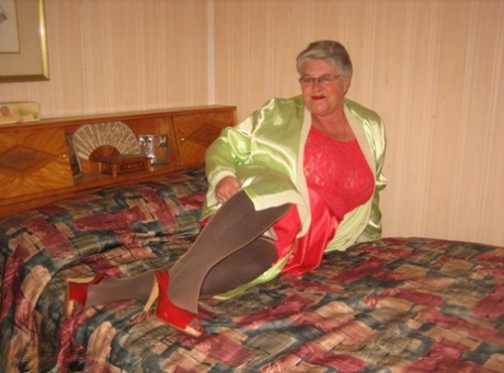Fat granny Girdle Goddess pets her femininity after stripping to hosiery on her bed