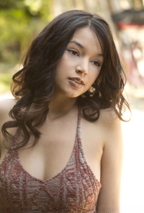 Gorgeous attractive young adult Eden Addams removes her shorts outside to lounge artistic