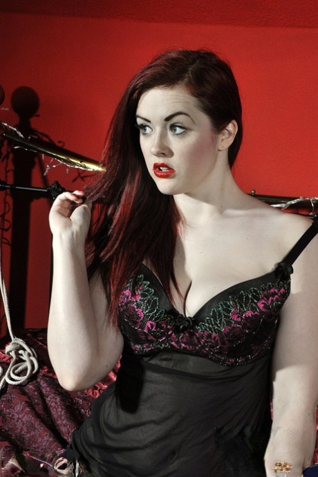 Redheaded solo girl creams her shaved femininity after hitching up her lingerie