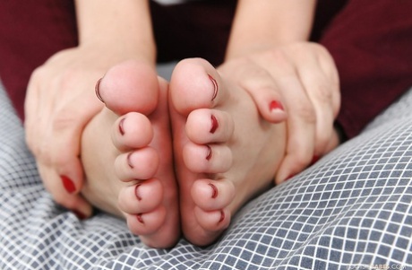 Foxy blonde babe Lexi Belle exposing her bare feet and stripping