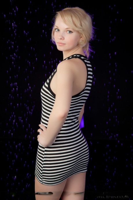 Smiley faced young adult Feeona A revealing toned body parts in the artistic