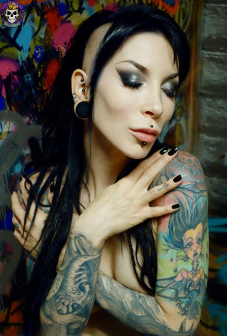 Goth girl Razor Candi strips to OTK boots in graffiti filled bathroom