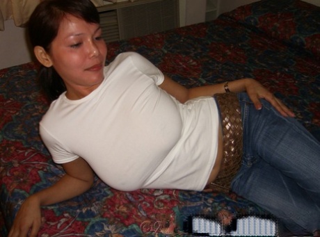 Filipina first timer cups her big naturals after undressing on a bed