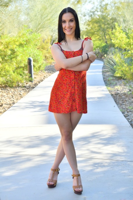 Cute brunette girl Jasmin shows her attractive figure before toying herself indoors