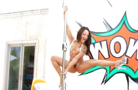Latina young adult Holly Hendrix showing off bare curves before working stripper pole