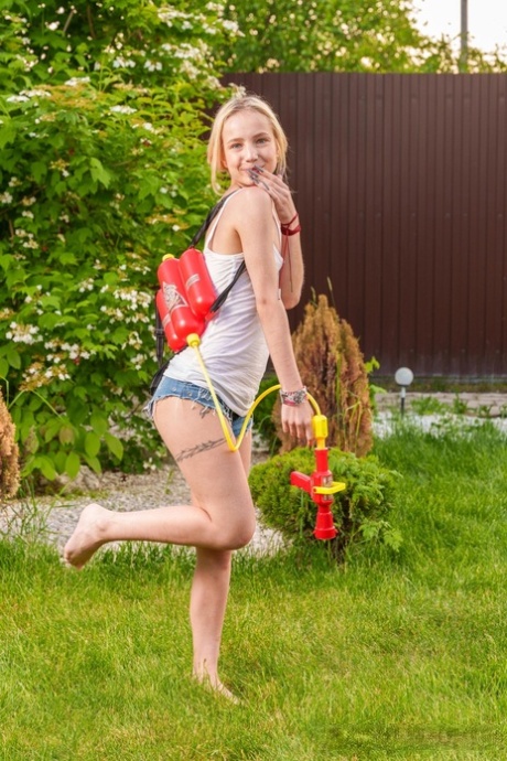 Slender European young adult Tea Mint flaunts her tiny breasts and masturbates outdoors