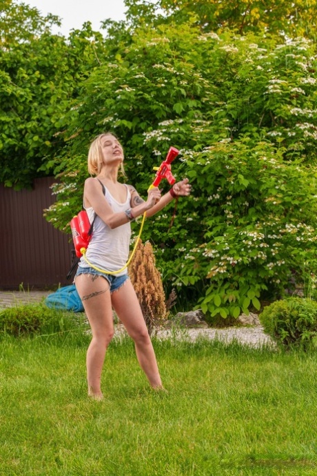 Slender European young adult Tea Mint flaunts her tiny breasts and masturbates outdoors