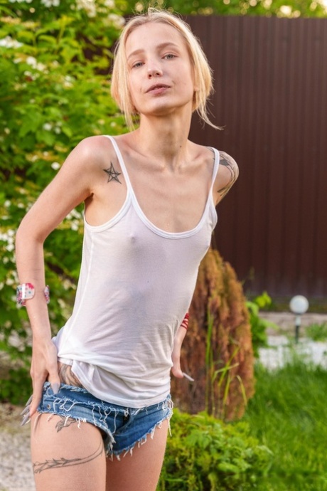 Slender European young adult Tea Mint flaunts her tiny breasts and masturbates outdoors