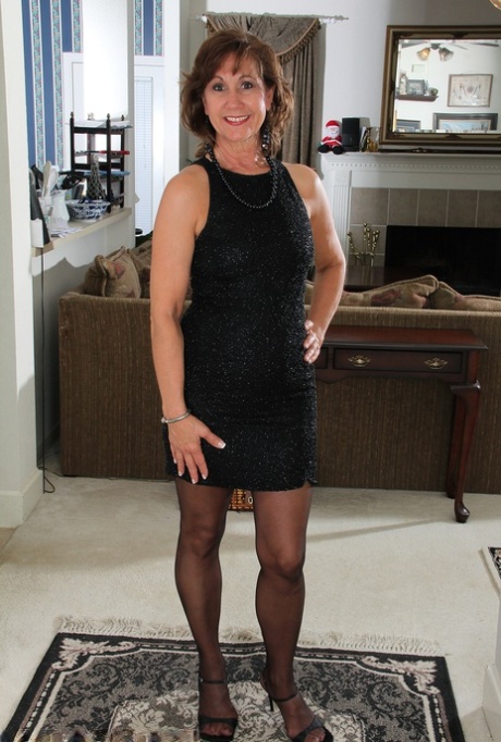 Mature wife Lynn showing off her saggy breasts & spread curves in black stockings