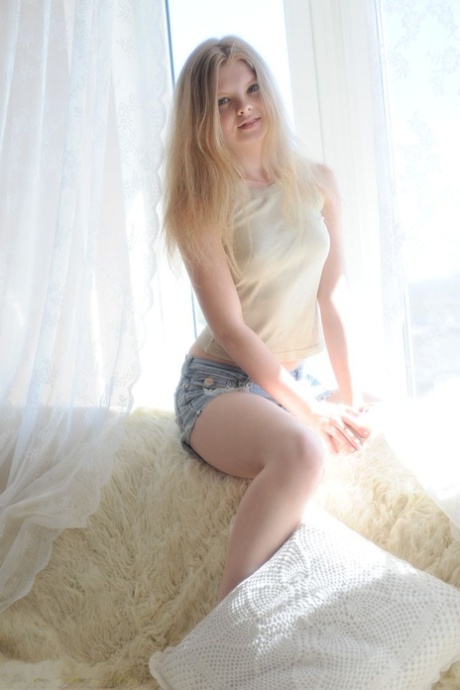 Fair skinned young adult Kisa removes jean shorts for totally artistic solo poses