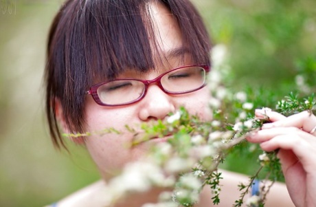 Hairy Asian authentic Gita slowly taking off her clothes outdoors