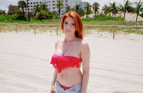 Redhead bombshell Rainia Belle showing off her round melons & amazing big curves