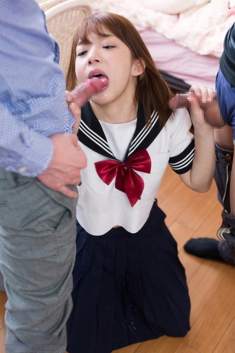 Japanese schoolgirl spits out climax after sucking off two cocks