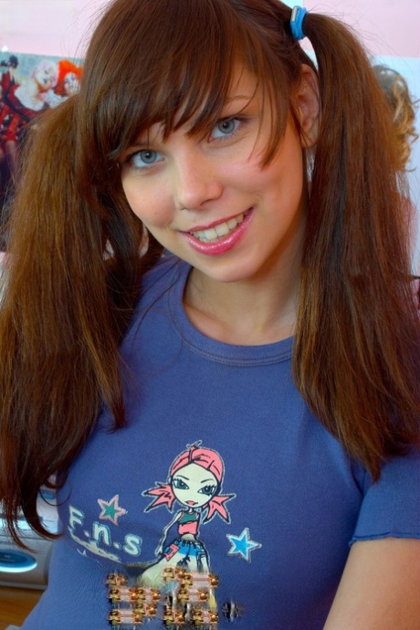 Cute young adult pulls down pink fishnets before masturbating in pigtails