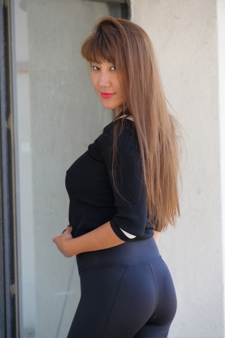 Busty MATURE WOMAN Tiffany poses in her alluring outfit before washing herself at the pool