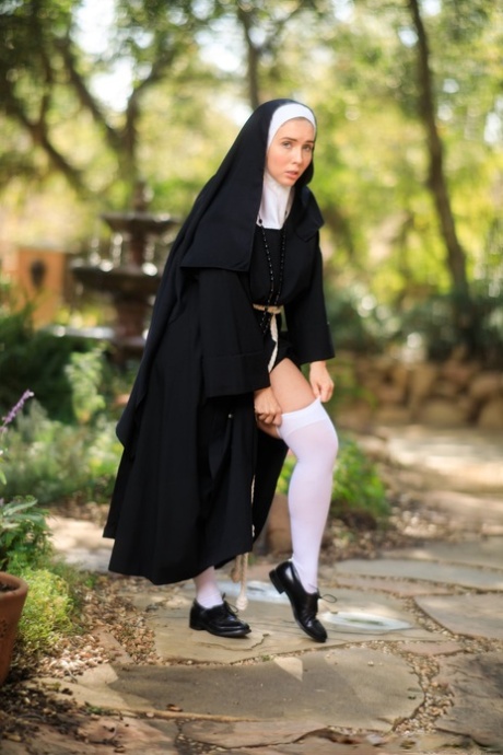 Thick Nun exposes herself in the courtyard wearing over the knee socks