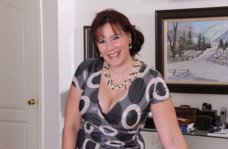 Thick aged woman takes off her dress and black lingerie to pose natural on couch