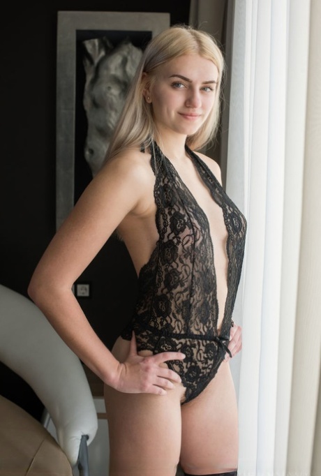 Young blonde girl shows her awesome bush in stockings after removing onesie