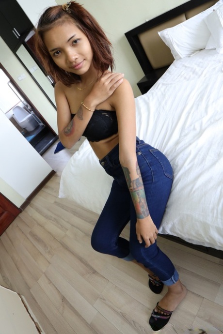 Pretty Asian girl Emelyn shows off her petite body while undressing for intimacy