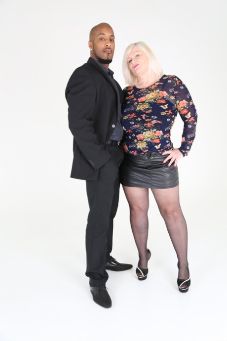 Blonde granny Lacey Starr eats a black manhood before riding it in stockings