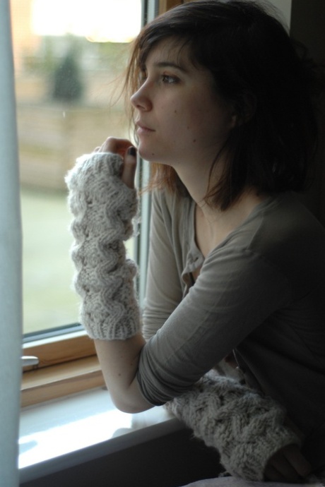 Thin young adult Estelle K gets natural in fingerless gloves while reading a Manga book