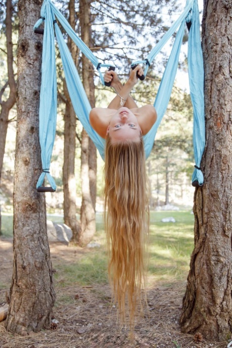 Marvelous babe Milena Angel strips natural & poses while swinging in the forest