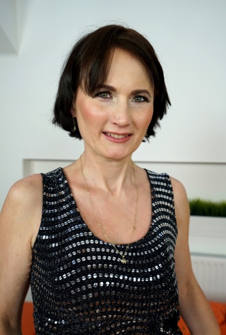 Short haired granny Alice Sharp bares her saggy breasts as she strips natural