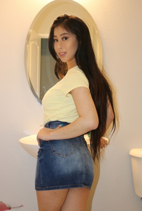 Asian beauty Jade Kush shows her damp snatch after unleashing large breasts