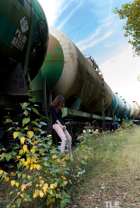 Brunette in pantyhose Rebeka Ruby toys herself while taking a piss outdoors