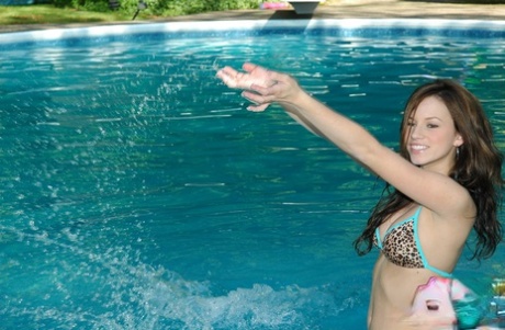 Young adult first timer models non artistic in a string bikini out in the pool