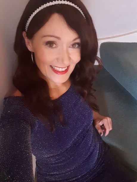 Alluring MATURE WOMAN Kitty Cream models for a non-nude shoot while at home and alone