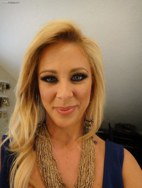 Curvy blonde pornstar Cherie Deville reveals her curves and fake breasts