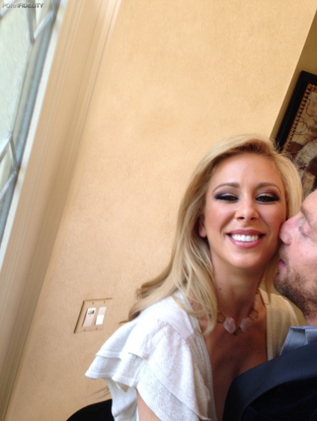 Curvy blonde pornstar Cherie Deville reveals her curves and fake breasts