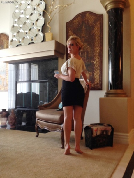 Curvy blonde pornstar Cherie Deville reveals her curves and fake breasts