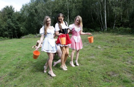 Horny femdom girls in costume head to the field to milk their natural man slave