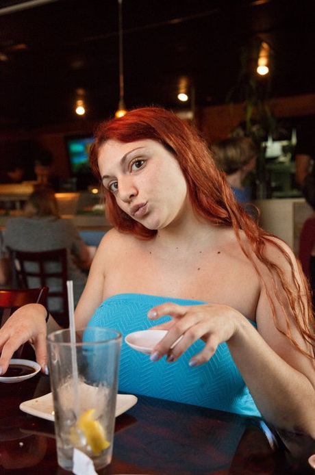 Curvaceous redhead Gina Rosini flashes her big breasts round curves and hairy twat