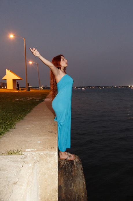 Curvaceous redhead Gina Rosini flashes her big breasts round curves and hairy twat