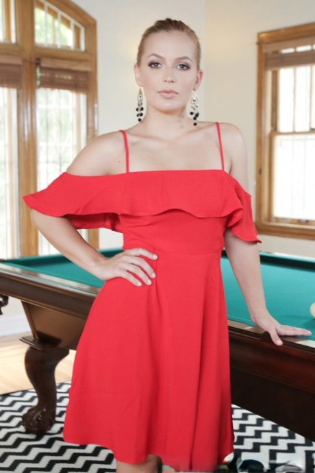 Long haired blonde in ponytail Sloan Harper shows her attractive stuff on pool table