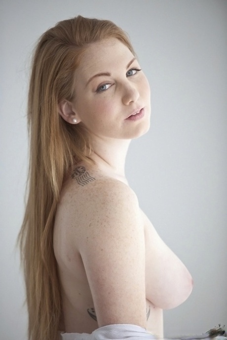 Cute babe Bre Pheonix uncovering her big breasts and fingering her slit