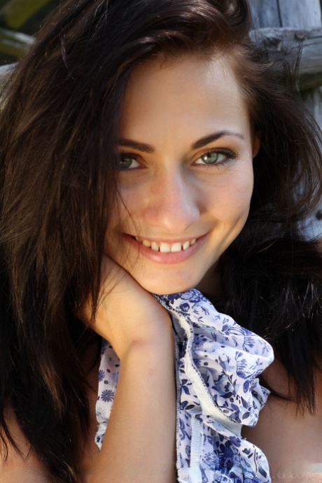 Leggy young adult solo girl Michaela Isizzu flashing white upskirt panties outside