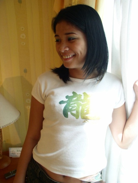 Young looking Asian girls undress on their bed for same-sex female intimacy