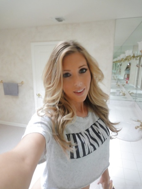 Young blonde Samantha Saint taking artistic selfies in the bathroom