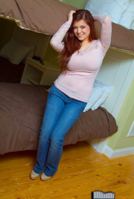 Big titted beauty strips off her jeans and sweater to pose with nice nipples