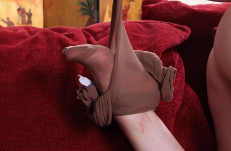 Mature blonde Holly Jones spreads her legs in tight pantyhose