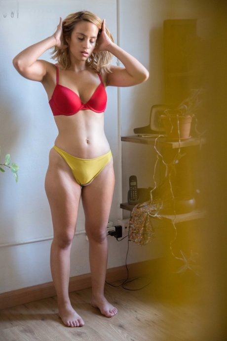 Natural white chick pulls on her bra and panties as she gets dressed