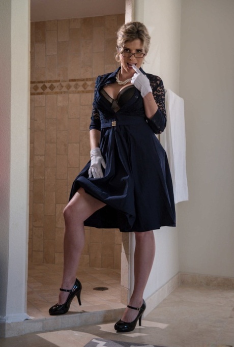 Nerdy MATURE WOMAN Cory Chase doffs her dress and flaunts her great fake breasts