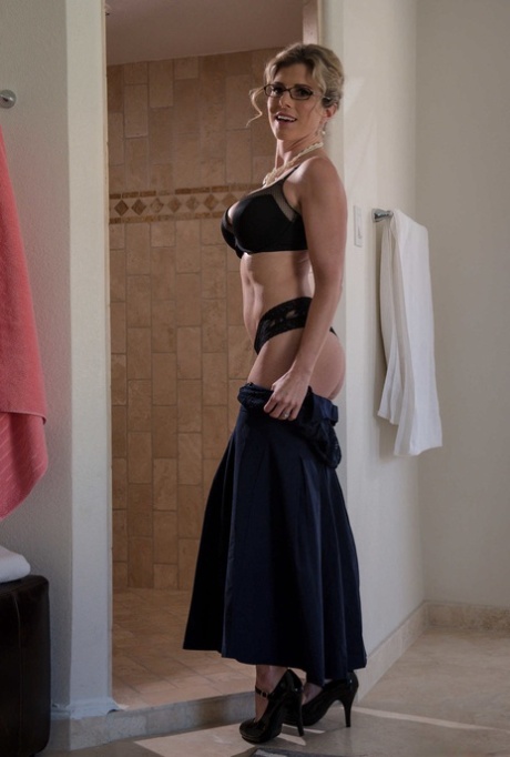 Nerdy MATURE WOMAN Cory Chase doffs her dress and flaunts her great fake breasts