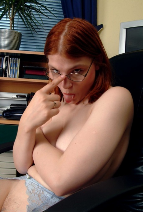 Authentic redheaded secretary Kelly M flaunts her big breasts and toys herself