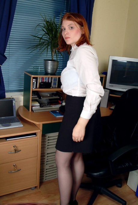 Authentic redheaded secretary Kelly M flaunts her big breasts and toys herself